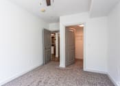 Thumbnail 20 of 28 - A room with a carpeted floor and two doors.