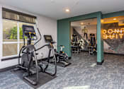 Thumbnail 23 of 28 - A gym with a neon sign that says "Don't Quit" in the background.