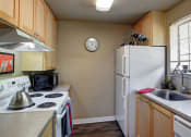 Thumbnail 23 of 34 - a kitchen with a stove refrigerator and sink at 2000 Lake Washington Apartments, Washington