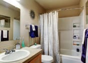 Thumbnail 25 of 34 - a bathroom with a sink toilet and a shower at 2000 Lake Washington Apartments, Renton