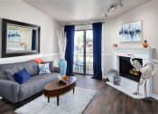 Thumbnail 21 of 34 - a living room with a fireplace and a couch at 2000 Lake Washington Apartments, Renton, WA