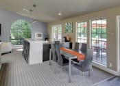 Thumbnail 34 of 34 - Resident clubhouse with long community table and hightop bar seating at 2000 Lake Washington Apartments, Renton, 98056
