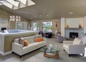 Thumbnail 33 of 34 - Resident clubhouse with a fireplace surrounded by lounge seating at 2000 Lake Washington Apartments, Renton, WA