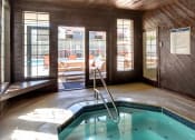 Thumbnail 30 of 34 - an indoor spa with a door to the outdoor pool area at 2000 Lake Washington Apartments, Renton, WA, 98056