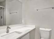 Thumbnail 11 of 34 - a bathroom with a sink and a toilet and a mirror at 2000 Lake Washington Apartments, Washington, 98056