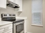 Thumbnail 3 of 34 - a kitchen with a stove and a window at 2000 Lake Washington Apartments, Renton, Washington