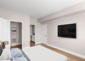 Thumbnail 6 of 33 - a bedroom with a bed and a tv on the wall at Plum Creek in Castle Rock, CO