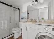 Thumbnail 7 of 31 - a bathroom with a toilet sink and a washing machine