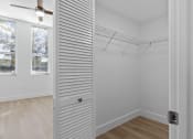 Thumbnail 31 of 56 - a closet in a bedroom with white walls and wood floors at One Plantation in Plantation, FL