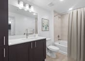Thumbnail 29 of 56 - a bathroom with a sink toilet and a shower at One Plantation in Plantation, Florida 33324