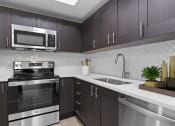 Thumbnail 26 of 56 - a kitchen with stainless steel appliances and a sink at One Plantation in Plantation, 33324