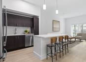 Thumbnail 27 of 56 - an open kitchen and living room with a white counter top at One Plantation in Florida 33324