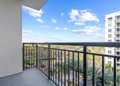 Thumbnail 25 of 56 - the view from the balcony of a condo with a blue sky and palm trees at One Plantation in FL 33324