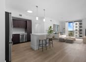 Thumbnail 20 of 56 - a living room with a kitchen and a dining room at One Plantation in Plantation, Florida