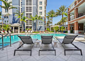 Thumbnail 33 of 59 - Lounge Chairs at Outdoor Pool at One Plantation Apartments in Plantation, FL 33324