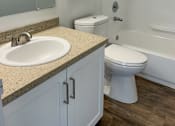 Thumbnail 19 of 34 - A white toilet sits next to a sink in a bathroom at 2000 Lake Washington Apartments, WA, 98056