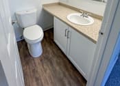 Thumbnail 16 of 34 - A white toilet sits in a small bathroom next to a sink at 2000 Lake Washington Apartments, Renton, Washington, 98056