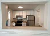 Thumbnail 13 of 34 - A kitchen with white cabinets and appliances at 2000 Lake Washington Apartments, Renton, WA