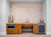 Thumbnail 10 of 42 - A kitchen with a wooden island and a microwave.