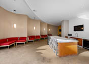 Thumbnail 15 of 42 - A modern kitchen with red chairs and a wooden island.