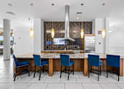 Thumbnail 19 of 42 - A kitchen area with a table and chairs.