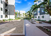 Thumbnail 42 of 42 - A sunny day at a modern residential area with apartment buildings and a clean, well-maintained courtyard.
