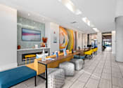 Thumbnail 25 of 42 - A modern waiting room with a fireplace and comfortable seating.