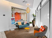 Thumbnail 16 of 42 - A modern living room with a grey sofa, a yellow chair and a glass wall.