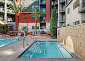 Thumbnail 34 of 42 - A small pool in a courtyard surrounded by buildings.