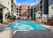 Thumbnail 32 of 42 - A swimming pool in a courtyard surrounded by buildings.
