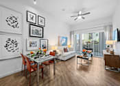 Thumbnail 2 of 42 - A modern dining room with a glass table and chairs.