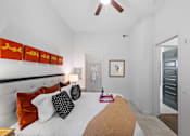 Thumbnail 5 of 42 - A bedroom with a bed, pillows, and a ceiling fan.