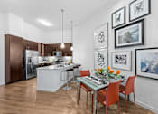 Thumbnail 21 of 42 - A kitchen with a dining table and chairs.