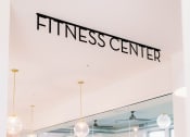 Thumbnail 28 of 39 - Entry to the fitness center with glass walls at The Merchant Apartments, Charleston, SC