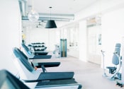Thumbnail 29 of 39 - a row of treadmills at the 24-hour fitness center at The Merchant Apartments, Charleston