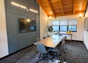 Thumbnail 30 of 30 - A conference room with a long table and chairs at The Lakes in Bellevue, WA 98007