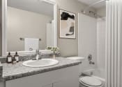 Thumbnail 17 of 32 - a bathroom with a sink and a toilet and a shower  at Arcadia Apartment Homes, Centennial, Colorado