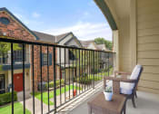 Thumbnail 23 of 40 - a patio with a chair and a table on a balcony