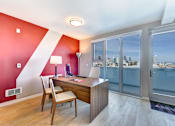 Thumbnail 32 of 43 - a home office with a desk and a view of the city at L Seven, CA 94103