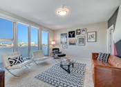 Thumbnail 19 of 43 - a living room with large windows and a leather couch at L Seven, California