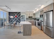 Thumbnail 20 of 43 - a kitchen with stainless steel appliances and a table with chairs at L Seven, San Francisco