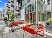 Thumbnail 28 of 43 - a foosball table on a patio in front of a building at L Seven, California, 94103