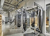 Thumbnail 36 of 43 - a gym with cardio machines and other equipment in a building at L Seven, San Francisco
