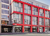 Thumbnail 39 of 43 - A building with red accents and L Seven logo at L Seven Apartments in San Francisco, CA
