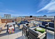 Thumbnail 25 of 43 - a roof top patio with tables and chairs and a view of the city at L Seven, San Francisco, 94103
