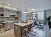 Thumbnail 15 of 43 - a kitchen and living room with a table and chairs at L Seven, CA 94103