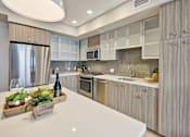 Thumbnail 12 of 43 - a kitchen with stainless steel appliances and white counter tops at L Seven, San Francisco, California 94103