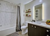 Thumbnail 11 of 43 - the residence on lamar apartment homes bathroom with toilet sink and shower at L Seven, CA 94103
