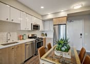 Thumbnail 1 of 43 - a kitchen with stainless steel appliances and a table with chairs at L Seven, San Francisco