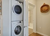 Thumbnail 6 of 43 - a front loading washer and dryer in a laundry room at L Seven, San Francisco, 94103
